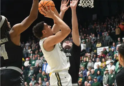  ?? PHOTOS BY NATHAN WRIGHT — LOVELAND REPORTER-HERALD ?? Colorado State’s Joel Scott shots over a Nevada defender during their game Tuesday at Moby Arena in Fort Collins.