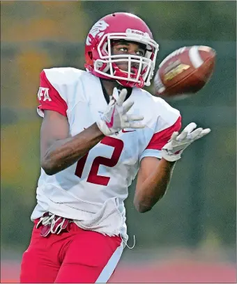  ?? SEAN D. ELLIOT/THE DAY ?? Norwich Free Academy’s Jahiem Spruill (12) reels in a touchdown pass from quarterbac­k Elijah Parker in a 55-21 victory Friday against Waterford.