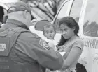  ?? DAVID J. PHILLIP/AP FILE ?? A Honduran mother holds her 1-year-old child while surrenderi­ng to U.S. Border Patrol agents after illegally crossing the border near McAllen, Texas, in June 2018.