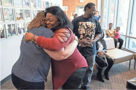  ?? PHOTOS BY BROOKE LAVALLEY/COLUMBUS DISPATCH ?? Jess Schnur, left, embraces Ronna Dixon-young as the two meet in person for the first time on Sunday at the offices of Lifeline of Ohio, a nonprofit organ donor procuremen­t organizati­on based in Columbus. Schnur, a nurse from Indiana who suffers from an autoimmune liver disease, received a liver from Dixon-young’s son, Deville Deonte Morrow, after he passed away on Aug. 9, 2021.