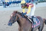  ?? CHELSEA DURAND/AP ?? Rajiv Maragh rides Irish War Cry to victory in the Wood Memorial horse race at Aqueduct Racetrack in New York.