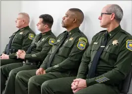  ?? PHOTOS BY MICHAEL WEBER — ENTERPRISE-RECORD ?? Left to right, Butte County Sheriff Kory Honea, Lt. Matthew Calkins, Chaplain Ed Hall and Lt. Stephen Collins listen to a speaker Friday during a memorial service at the Butte County Sheriff’s Office in Oroville.