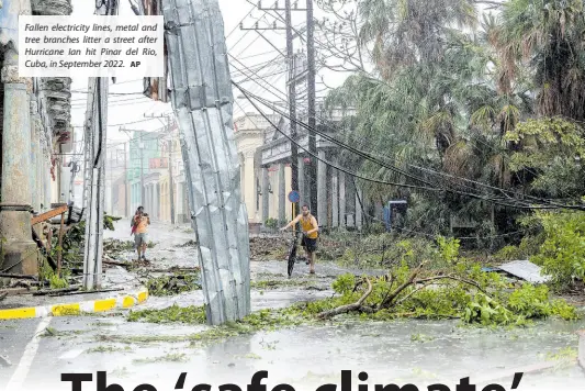  ?? AP ?? Fallen electricit­y lines, metal and tree branches litter a street after Hurricane Ian hit Pinar del Rio, Cuba, in September 2022.