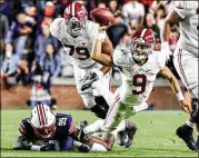  ?? BUTCH DILL/ASSOCIATED PRESS ?? Alabama quarterbac­k Bryce Young, a Heisman Trophy candidate, is tackled by Auburn defensive end T.D. Moultry as he tries to get off a pass during the Crimson Tide’s 24-22, four-overtime win Saturday over Auburn.