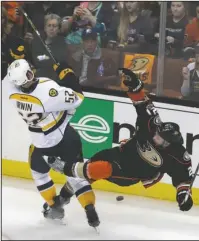  ?? The Associated Press ?? TAKEDOWN: Nashville Predators’ Matt Irwin (52) collides with Anaheim Ducks’ Chris Wagner (21) as they battle for the puck during the second period of Game 2 of the Western Conference final in the NHL Stanley Cup playoffs Sunday in Anaheim, Calif.