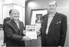  ??  ?? Hanif (left) and Ahmad Sarji showing the ‘Remembered, Preserved And Imagines Past: My Heritage Memoirs’ book during the launching in Kuala Lumpur. — Bernama photo