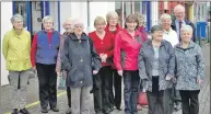  ??  ?? Some of the volunteers and Graham MacQueen gather for a photograph outside of the well-known charity shop.