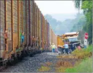  ?? PHOTO BY JOHN BECHTOLD ?? The train is stopped after hitting the dump truck.