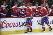  ?? NICK WASS — THE ASSOCIATED PRESS ?? Washington Capitals left wing Alex Ovechkin (8), of Russia, celebrates his goal with teammate Dmitry Orlov (9), also of Russia, and others against the Philadelph­ia Flyers, Sunday in Washington.