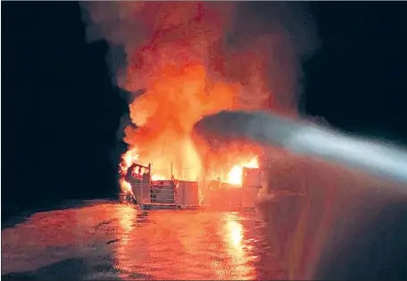  ?? Ventura County Fire Department ?? VESSELS built before 1996 were granted special exemptions from safety standards that the Coast Guard imposed on new boats, records show. Above, the Conception dive boat burns after catching fire in the early morning of Sept. 2 while anchored off Santa Cruz Island, Calif.