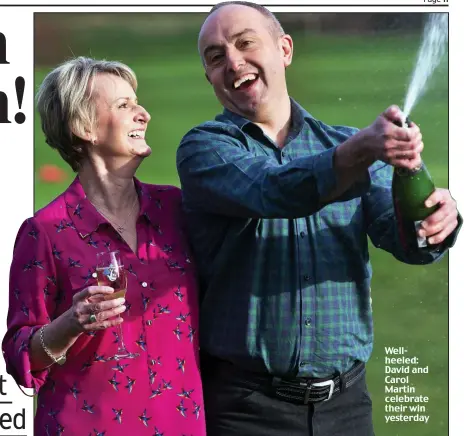  ??  ?? Wellheeled: David and Carol Martin celebrate their win yesterday