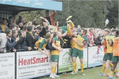  ?? ?? Horsham’s players and fans celebrate the dramatic win over Woking that earned them a place in the first round
Picture: John Lines