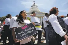  ??  ?? Supporters of a measure to limit when companies can label workers as independen­t contractor­s rally at the Capitol in July.