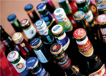  ?? Picture: BLOOMBERG ?? Bottles of SABMiller beer brands including Castle, Carling Blue Label, Hansa Pilsener, Milk Stout, Perroni Nastro Azzurro and Redd’s.