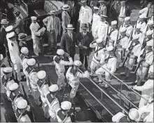  ?? AP PHOTO ?? The crew of the Sequoia presents arms as President Franklin Roosevelt, leaning on the arm of his son James Roosevelt, goes on board in New Haven on June 20, 1934, to sail to New London for the Yale-Harvard Regatta.