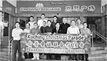  ??  ?? Ting (front row, left) and organising committee members hold a banner of the Kuching Christmas Parade which takes place this Saturday. Also seen is Ambrose (front row, third right).