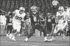  ?? ASSOCIATED PRESS ?? NAVY QUARTERBAC­K DALEN MORRIS (8) looks to throw as BYU defensive lineman Zac Dawe (99) rushes in during the first half of an NCAA college game Monday in Annapolis, Md.