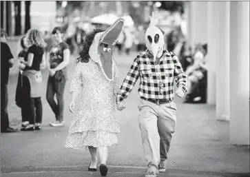  ?? Photograph­s by Michael Baker
For The Times ?? DRESSED AS “BEETLEJUIC­E” characters, Delores Tejeda and Clifford Sisneros stroll at Hollywood Bowl.