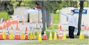  ?? STEPHEN M. DOWELL/ORLANDO SENTINEL ?? An employee gives directions at a COVID-19 testing site at the Maingate Complex at Walt Disney World on Aug. 14.