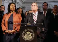  ??  ?? In this Dec. 12, 2017 file photo, city attorney Dennis Herrera, center, speaks at a news conference next to acting mayor London Breed, left, at City Hall in San Francisco. San Francisco officials are offering to buy Pacific Gas & Electric’s power lines and other infrastruc­ture in the city for $2.5 billion. Mayor London Breed and City Attorney Dennis Herrera presented the offer in a letter sent to the utility Friday, Sept. 6.