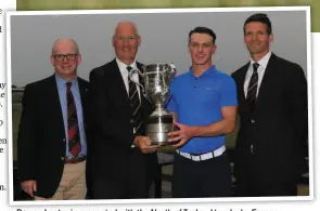  ??  ?? Rowan Lester is presented with the North of Ireland trophy by Eamonn O’Connor (Chairman GUI Ulster Branch), David McMullan (Captain, Royal Portrush) and Andrew Spence (Cathedral Eye Clinic) Picture: GOLFFile.ie