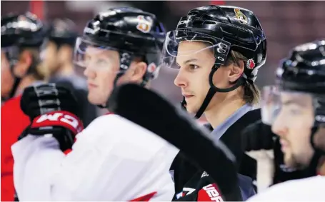  ?? JEAN LEVAC/OTTAWA CITIZEN ?? From left, Erik Condra, Erik Karlsson and Cory Conacher follow the play during practice on Friday. Karlsson will play tonight against Philadelph­ia, but he may sit out in Boston on Sunday, depending on the Senators’ playoff situation.