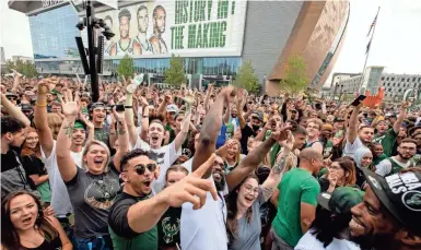  ?? JULIA MARTINS DE SA/MILWAUKEE JOURNAL SENTINEL ?? Fans gather outside Fiserv Forum before the start of Game 6 of the NBA Finals between the Milwaukee Bucks and the Phoenix Suns on Tuesday.