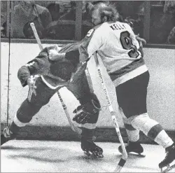  ?? AP PHOTO ?? In this Feb. 2, 1974, file photo, Philadelph­ia Flyers’ Bob Kelly, right, and Larry Johnson of the Detroit Red Wings square off for a few moments in the first period of an NHL game in Philadelph­ia