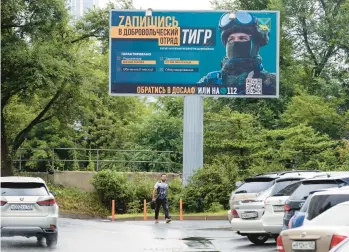  ?? AP ?? A billboard seen Thursday in Vladivosto­k, Russia, encourages people to sign up for the Tiger volunteer battalion.