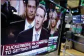  ?? RICHARD DREW — THE ASSOCIATED PRESS ?? Facebook CEO Mark Zuckerberg appears on a television screen on the floor of the New York Stock Exchange as he testifies in the Senate in Washington, Tuesday.