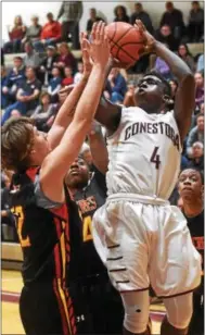  ?? PETE BANNAN — DIGITAL FIRST MEDIA ?? Conestoga’s Milton Robinson’s scores over a Penncrest defender in the fourth quarter Friday.