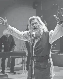  ?? MICHAEL GIBSON/ NETFLIX ?? Santa Claus ( Kurt Russell) jams with a prison soul band in 2018’ s “The Christmas Chronicles.” He gets a new duet partner in the sequel.