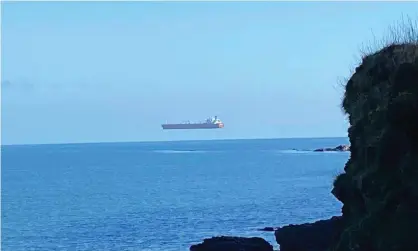  ?? Photograph:David Morris/Apex ?? A tanker appears to hover high above the surface of the sea off the Cornish coast.