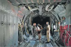  ?? AFP ?? Taliban fighters stand inside an Afghan Air Force aircraft at the airport in Kabul on Tuesday after the US pull all its troops out of the country to end a brutal 20-year war .