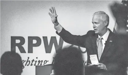  ?? EBONY COX / MILWAUKEE JOURNAL SENTINEL ?? A supporter raises his fist after U.S. Sen. Ron Johnson says his final thoughts during the 2022 state Republican Party convention in Middleton Saturday.