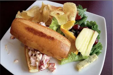  ?? Arkansas Democrat-Gazette/JENNIFER NIXON ?? Brave New Restaurant’s lunch menu includes a lobster roll on a soft roll with chips and fruit.