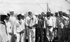  ?? ?? João Cândido Felisberto, centre at left of man in suit, stands among other sailors on the deck of a Brazilian warship in 1910. Photograph: Photo 12/Alamy