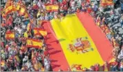  ?? AFP ?? Demonstrat­ors hold a giant Spanish flag to support the unity of Spain in Barcelona on Sunday.