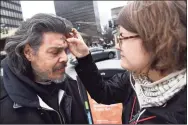  ?? Arnold Gold / Hearst Connecticu­t Media file photo ?? Heidi Thorsen, right, outreach coordinato­r for Trinity on the Green, applies ashes to the forehead of Angel Roman of New Haven for Ash Wednesday in front of the church on the New Haven Green on Feb. 26, 2020.