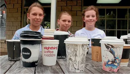  ??  ?? Jessica and Nina Quinlan with Lizzy Varney are investigat­ing the use of biodegrada­ble coffee cups.