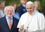  ?? PETER MORRISON / AP ?? Pope Francis is flanked by Irish President Michael D. Higgins at the Presidenti­al residence Saturday in Dublin, Ireland. Pope Francis faced a lukewarm reception and scattered protests from the public.