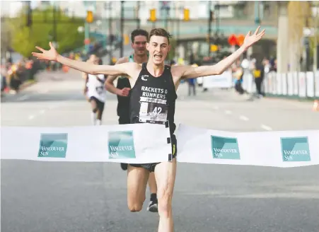  ?? ARLEN REDEKOP/FILES ?? Justin Kent of Burnaby was the first man to cross the finish line as thousands showed up for the 2019 Sun Run in Vancouver.