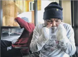  ??  ?? RAZAK IYAL, front, and Seidu Mohammed lost most of their fingers after getting lost in sub-freezing temperatur­es while crossing from the U.S. into Canada.