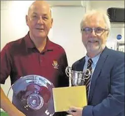  ?? ?? Mike Cunningham receives his trophies from Derek Richard, managing director of sponsors Golfstream