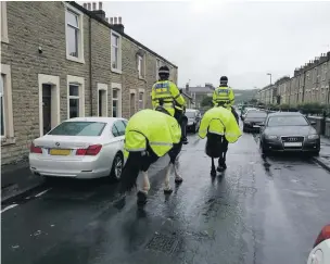  ??  ?? A police patrol on Richmond Hill Street in Accrington after the incident