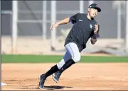  ?? ANDY CROSS The Denver Post ?? Rockies infielder Alan Trejo performs a base-running drill during spring training at Salt River Fields at Talking Stick in Scottsdale, Ariz.