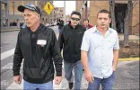  ??  ?? Juan Carlos Hernandez Pacheco (center), arrested for being an unauthoriz­ed immigrant, walks with friends after being freed on bond Wednesday in St. Louis. A judge cited strong community support Hernandez has received in West Franklin, Ill., where he...