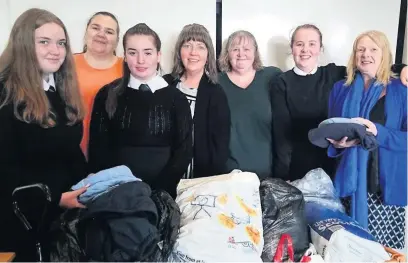  ??  ?? Helping hand Adult volunteers (l-r) Leeann Campbell, Lynn Carlin, Audrey Tweedie and Clare O’Neill with Airdrie Academy pupils (l-r) Heather Lewis, Emily Arthur and Hannah Tweedie who gave up their own time to help with stock control