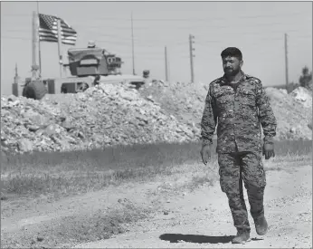  ?? AP PHOTO ?? A U.S-backed Syrian Manbij Military Council soldier passes a U.S. position near the front line with Turkish-backed fighters, in Manbij, north Syria. The People’s Protection Units, known by their Kurdish acronym YPG, said in a statement Tuesday, that...