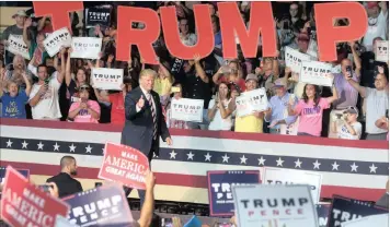  ??  ?? Republican presidenti­al candidate Donald Trump waves to the crowd during a rally in Roanoke, Virginia, on Saturday. Trump faces Democratic opponent Hillary Clinton in the first of three debates today. World markets will watch with interest.